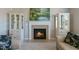 Cozy living room with a fireplace, built-in display cabinets, and natural light at 708 Barley Green St, Wake Forest, NC 27587