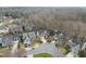 Aerial view of homes in a well-maintained neighborhood, showcasing mature trees and landscaping at 8720 Deerland Grove Dr, Raleigh, NC 27615