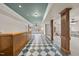 Basement featuring a custom bar area, checkered flooring, and support columns at 8720 Deerland Grove Dr, Raleigh, NC 27615