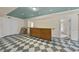 Spacious basement featuring a custom bar area, checkered flooring, and recessed lighting at 8720 Deerland Grove Dr, Raleigh, NC 27615
