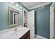 Well-lit bathroom with a marble countertop vanity and a classic gold framed mirror at 8720 Deerland Grove Dr, Raleigh, NC 27615