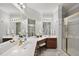 Bathroom vanity area featuring lots of counter space, dark wood cabinets, and large mirrors at 8720 Deerland Grove Dr, Raleigh, NC 27615