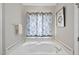 Bathroom with a soaking tub, white cabinets, and blue patterned curtain at 8720 Deerland Grove Dr, Raleigh, NC 27615