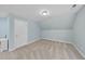 Slanted ceiling bedroom with light blue walls, neutral carpet, and ample natural light at 8720 Deerland Grove Dr, Raleigh, NC 27615