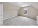 Bedroom features neutral paint, plush carpet, a window, and is brightly illuminated by overhead lighting at 8720 Deerland Grove Dr, Raleigh, NC 27615