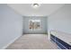Comfortable bedroom with bright blue walls, carpet, and a window at 8720 Deerland Grove Dr, Raleigh, NC 27615