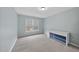 Bright, carpeted bedroom with light blue walls, dresser and a window at 8720 Deerland Grove Dr, Raleigh, NC 27615
