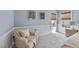 Comfortable bedroom featuring blue accent wall, accent chair, and beautiful natural light at 8720 Deerland Grove Dr, Raleigh, NC 27615