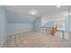 Large bonus room with carpet flooring, plenty of space, and natural light at 8720 Deerland Grove Dr, Raleigh, NC 27615