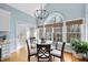 Sunlit dining room with a round glass table and bright windows at 8720 Deerland Grove Dr, Raleigh, NC 27615