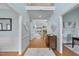 Inviting home entryway with hardwood floors, light blue walls, and decorative trim that leads into the living room at 8720 Deerland Grove Dr, Raleigh, NC 27615