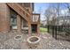 Firepit area with stone pavers and river rock, adjacent to the wooden deck at 8720 Deerland Grove Dr, Raleigh, NC 27615