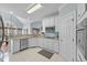 Well-lit kitchen with stainless steel appliances, white cabinets, and granite countertops at 8720 Deerland Grove Dr, Raleigh, NC 27615