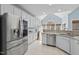 Spacious kitchen featuring granite countertops, stainless steel appliances, and vaulted ceiling at 8720 Deerland Grove Dr, Raleigh, NC 27615