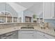 Close-up of kitchen sink featuring granite countertops and view to the living room at 8720 Deerland Grove Dr, Raleigh, NC 27615