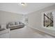 Inviting living room featuring plush carpeting, natural light, and neutral walls at 8720 Deerland Grove Dr, Raleigh, NC 27615