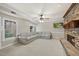 Spacious living room featuring a stone fireplace, gray sectional couch, and lots of natural light at 8720 Deerland Grove Dr, Raleigh, NC 27615