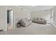 Bright living room with neutral tones and comfortable seating, carpeted flooring, and ample natural light at 8720 Deerland Grove Dr, Raleigh, NC 27615