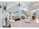 Bright living room featuring vaulted ceilings, fireplace, and staircase at 8720 Deerland Grove Dr, Raleigh, NC 27615