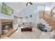 Comfortable living room with a brick fireplace, large windows, and cozy seating at 8720 Deerland Grove Dr, Raleigh, NC 27615