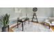 Inviting home office with hardwood floors, modern decor, and a well-lit workspace with a bookshelf at 8720 Deerland Grove Dr, Raleigh, NC 27615