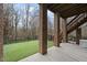Outdoor living space includes patio, stairs to the backyard, and artificial turf at 8720 Deerland Grove Dr, Raleigh, NC 27615