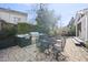 Outdoor kitchen with a built-in grill and metal dining set for entertaining in the backyard at 920 W Johnson St, Raleigh, NC 27605