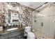 Beautiful bathroom with granite vanity, glass shower, and stylish floral wallpaper at 920 W Johnson St, Raleigh, NC 27605