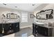 Elegant bathroom featuring dual vanities with marble countertops and unique ornate mirrors at 920 W Johnson St, Raleigh, NC 27605