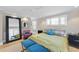 Bright bedroom with large mirror, hardwood floors, and a colorful bed at 920 W Johnson St, Raleigh, NC 27605