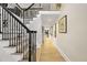 Bright foyer featuring a staircase, hardwood floors, and views into the living spaces at 920 W Johnson St, Raleigh, NC 27605