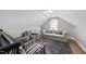 Cozy finished attic area featuring designer furniture, area rug and interesting arched window at 920 W Johnson St, Raleigh, NC 27605