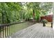 Spacious wood deck offers plenty of room for outdoor relaxation amidst a wooded backdrop at 9249 Miranda Dr, Raleigh, NC 27617