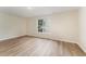 Bedroom featuring hardwood style floors, window, and neutral paint at 9249 Miranda Dr, Raleigh, NC 27617