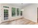 Breakfast nook with an outdoor view, wood floors, and an access door to the patio at 9249 Miranda Dr, Raleigh, NC 27617