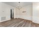 Dining room with a modern chandelier, hardwood floors, and decorative wall trim at 9249 Miranda Dr, Raleigh, NC 27617