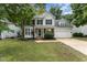 Charming two-story home featuring a well-manicured lawn, brick accents, and a two-car garage at 9249 Miranda Dr, Raleigh, NC 27617