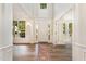 Bright foyer with soaring ceilings, hardwood floors, transom windows, and a decorative rug at 9249 Miranda Dr, Raleigh, NC 27617