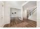 Open foyer featuring hardwood floors, high ceilings, and an entry to a home office space at 9249 Miranda Dr, Raleigh, NC 27617