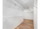 Walk-in closet with wire shelving and hardwood style floors at 9249 Miranda Dr, Raleigh, NC 27617