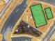 Aerial view of tennis and pickleball courts within the community, featuring walking trails and a parking area at 1016 Channel Drop Lp, Zebulon, NC 27597