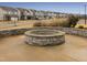 Cozy community fire pit area with stone seating, perfect for gatherings and relaxation at 1016 Channel Drop Lp, Zebulon, NC 27597