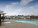 Community pool with ample seating, ideal for relaxing and enjoying sunny days at 1016 Channel Drop Lp, Zebulon, NC 27597