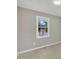 A neutral bedroom features a window providing plenty of natural light at 1041 Limerick Ln, Durham, NC 27713