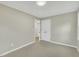 A clean bedroom featuring light gray walls, a neutral carpet, and double door closet at 1041 Limerick Ln, Durham, NC 27713