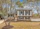 Charming two-story home featuring a brick and vinyl facade, complemented by a well-maintained lawn and mature trees at 1041 Limerick Ln, Durham, NC 27713