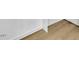 Close-up of new and well-maintained wood-look laminate flooring against clean white baseboards at 1041 Limerick Ln, Durham, NC 27713