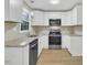 Updated kitchen with granite countertops, stainless steel appliances, and new white cabinets at 1041 Limerick Ln, Durham, NC 27713