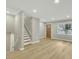 Inviting living space with sleek flooring, featuring a staircase and a front door with glass accents at 1041 Limerick Ln, Durham, NC 27713