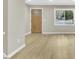 Open-concept living space with a stylish wood-look flooring and a bright window overlooking a charming view at 1041 Limerick Ln, Durham, NC 27713